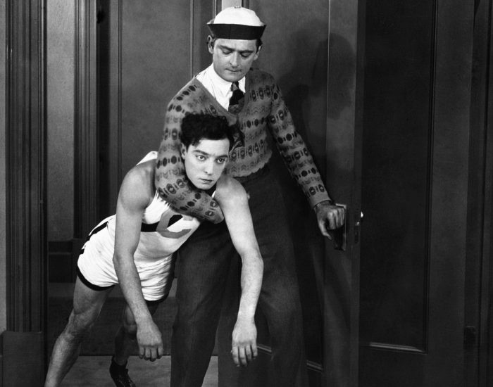 1927: An actor carries Buster Keaton, in the role of Ronald, in the 1927 movie College.